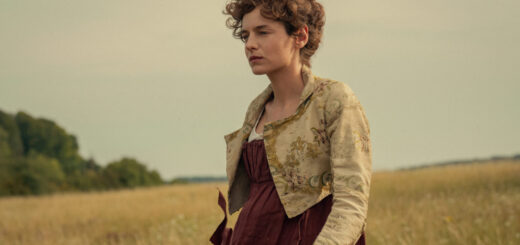 "Woman in historical dress standing in a field with tall grass, trees in the background, and a cloudy sky, creating a calm, pastoral setting."